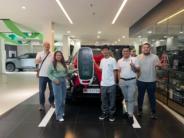 New owners and Nissan SVC Sucat staff in the showroom with the oversized key